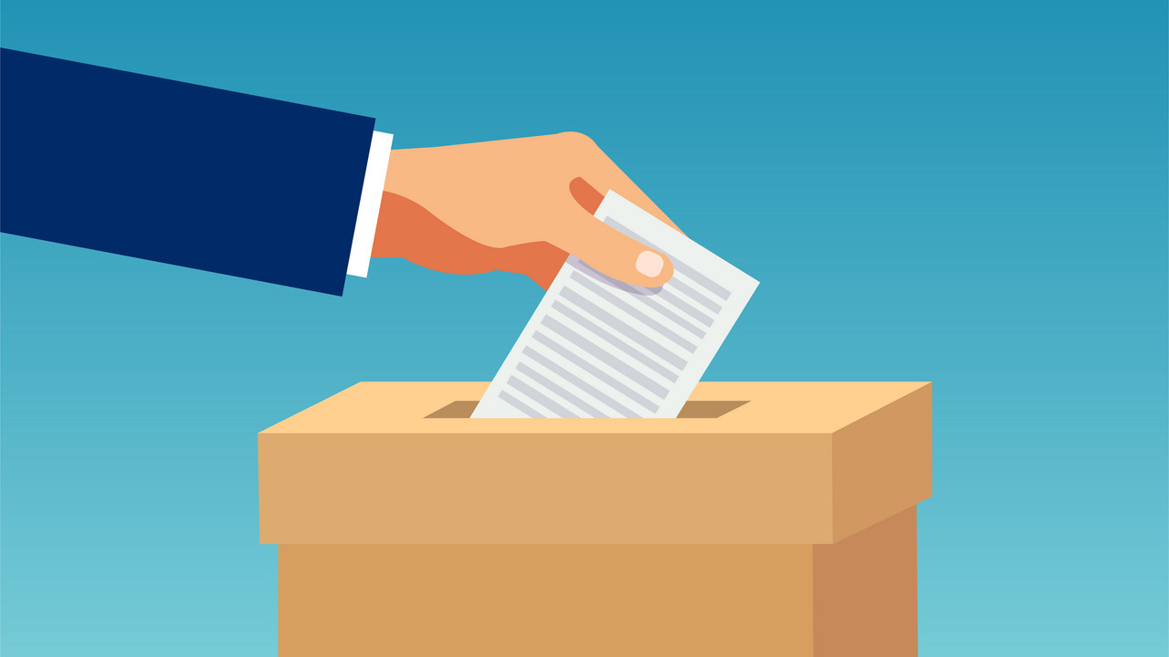 Vector of a hand inserting in box a ballot paper