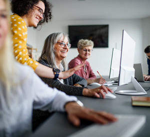 Group of senior people attending computer and technology education class.
