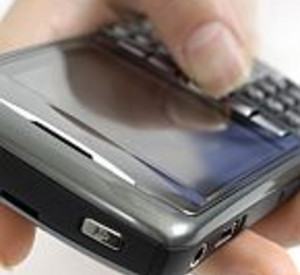 Hand with BlackBerry 8310 Curve Smartphone Isolated silhouette on white...