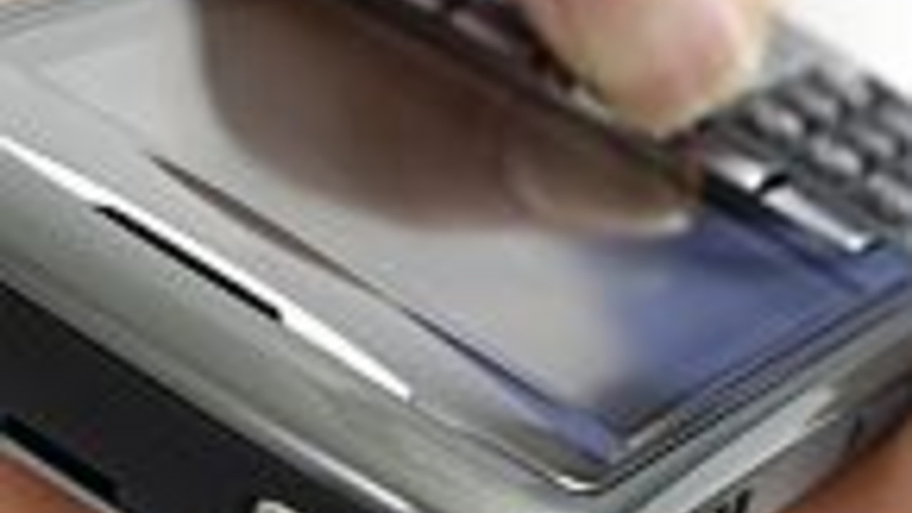 Hand with BlackBerry 8310 Curve Smartphone Isolated silhouette on white...