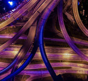 Großer Autobahn-Verteiler bei Nacht aus der Vogelperspektive